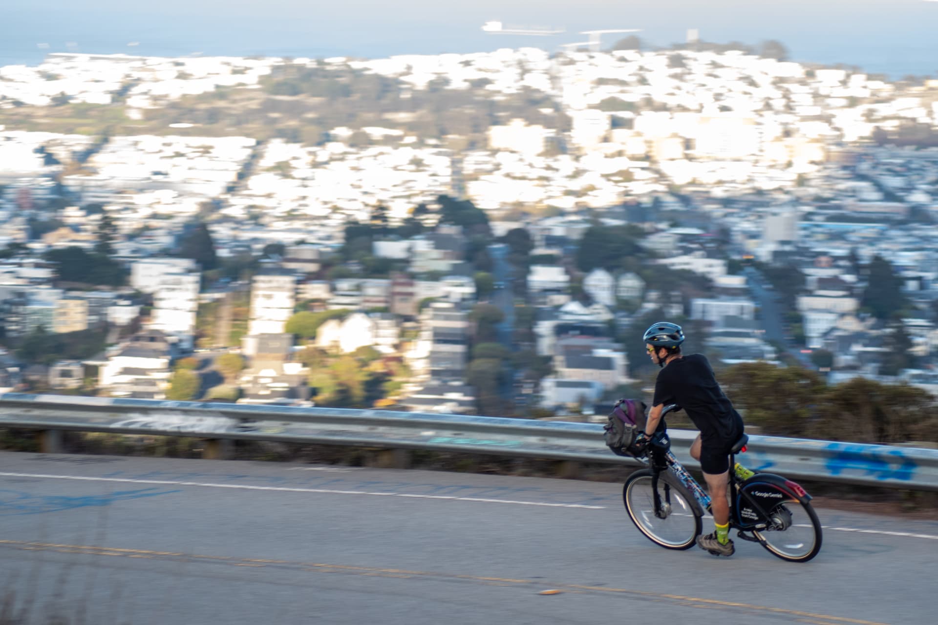 Descending at full speed on Twin Peaks, San Francisco, city blurred below