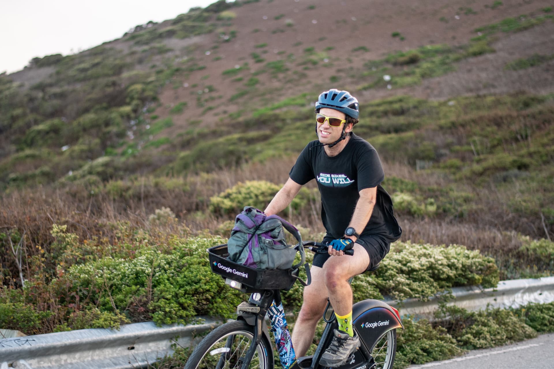 Rolling past a hillside at golden hour in San Francisco with a backpack in the basket